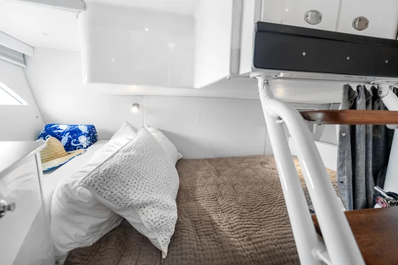 Slide: The Image of 2024 Intrepid 41 Valor cabin interior with cozy bedding and modern design. - 24