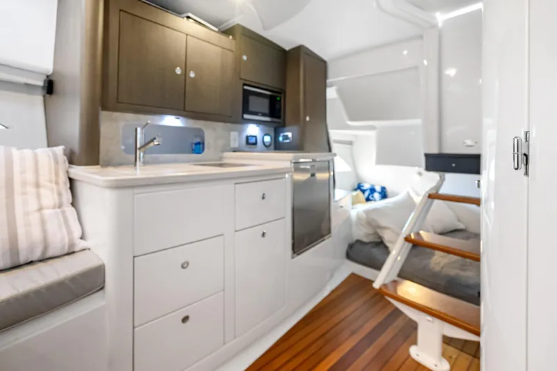 Slide: The Image of Luxurious interior of 2024 Intrepid 41 Valor yacht with modern kitchen and cozy seating. - 25