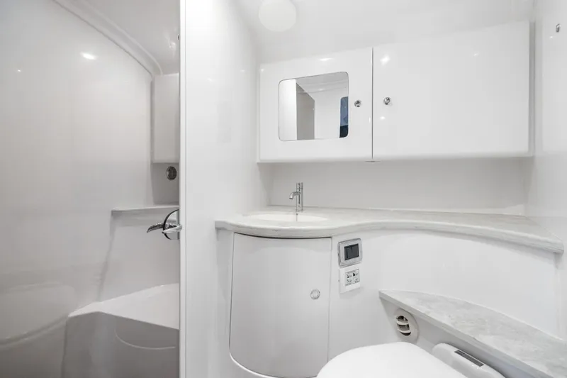 Slide: The Image of 2024 Intrepid 41 Valor yacht bathroom with sleek white design and modern fixtures. - 28