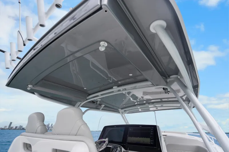 Slide: The Image of 2024 Intrepid 41 Valor boat helm with modern dashboard and seating, under a sleek canopy. - 29
