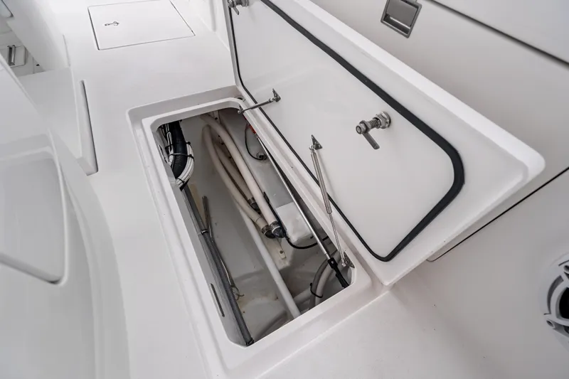 Slide: The Image of 2024 Intrepid 41 Valor boat storage compartment with open hatch and visible interior components. - 32