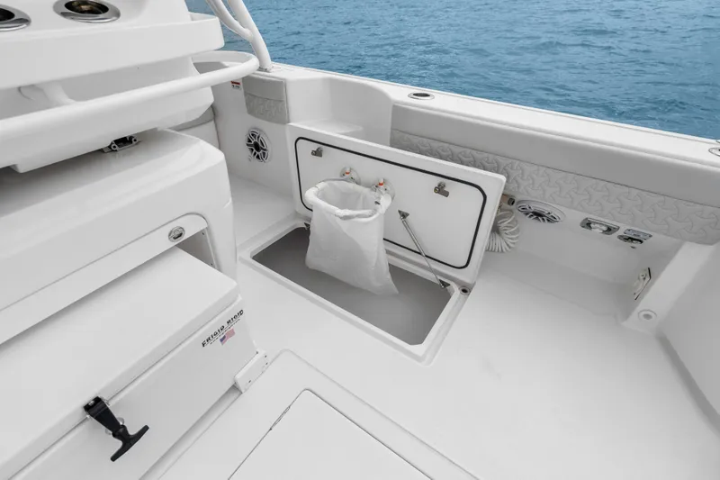 Slide: The Image of 2024 Intrepid 41 Valor boat interior with storage compartment and ocean view. - 34