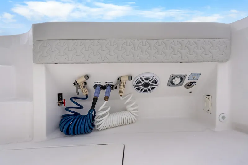 Slide: The Image of 2024 Intrepid 41 Valor boat utility panel with hoses and speaker. - 35