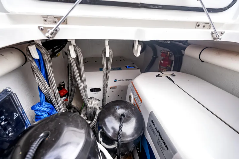 Slide: The Image of Storage compartment of 2024 Intrepid 41 Valor boat with ropes, equipment, and fire extinguisher. - 37