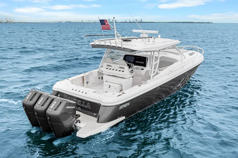 Slide: The Image of 2024 Intrepid 41 Valor boat cruising on open water with triple Mercury engines. - 5