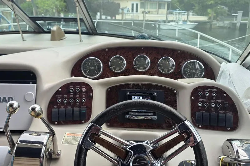 Slide: The Image of 2004 Sea Ray 340 Sundancer yacht docked, featuring spacious seating and elegant design. - 11