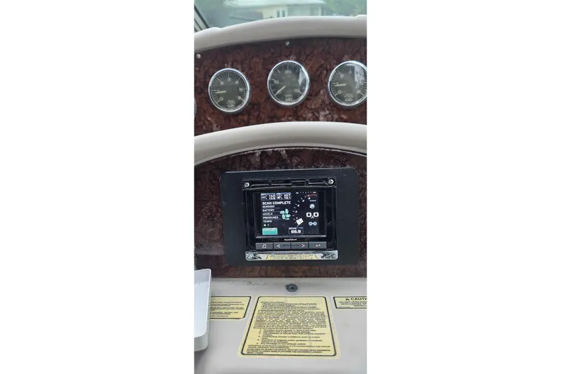 Slide: The Image of 2004 Sea Ray 340 Sundancer interior with teak flooring and control panel. - 12