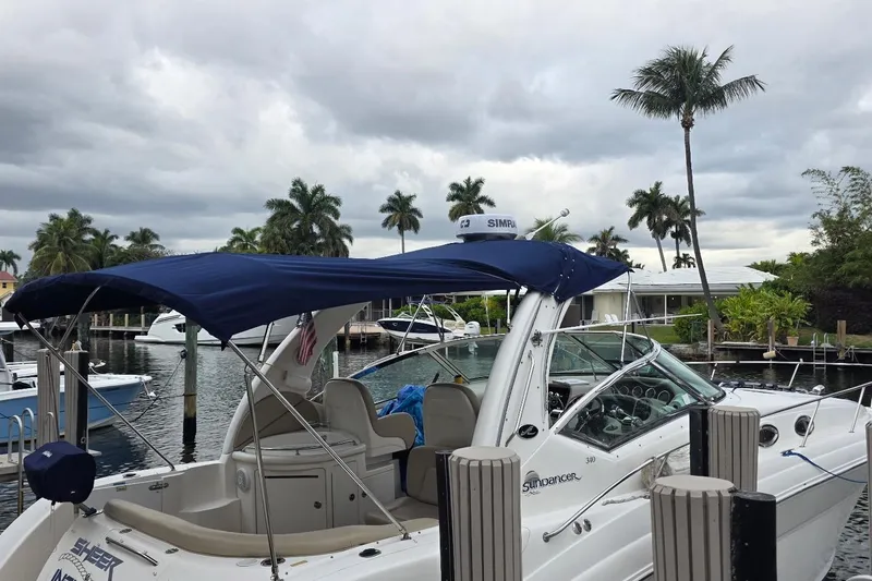 Slide: The Image of 2004 Sea Ray 340 Sundancer docked at marina, sunny day, palm trees in background. - 2