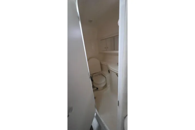 Slide: The Image of 2004 Sea Ray 340 Sundancer boat interior with kitchenette and seating area. - 20