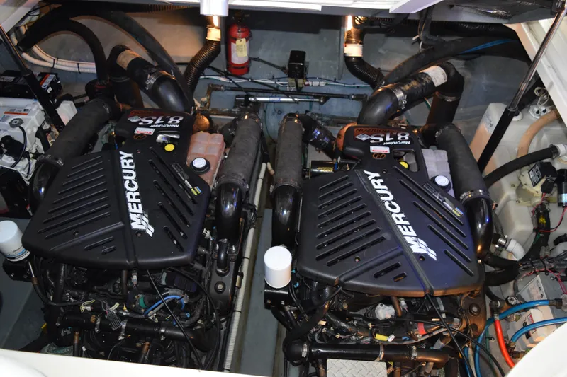 Slide: The Image of Interior of a 2004 Sea Ray 340 Sundancer boat with luxurious seating and helm. - 25