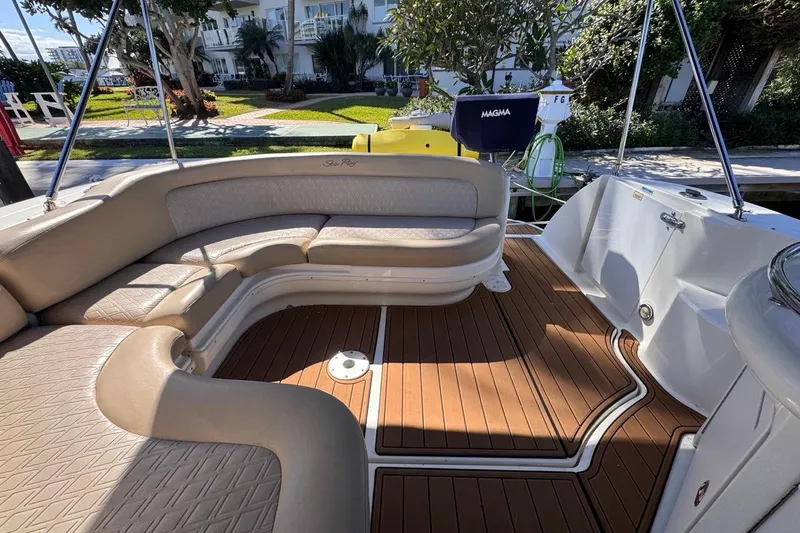 Slide: The Image of 2004 Sea Ray 340 Sundancer boat interior with beige seating and teak flooring. - 28