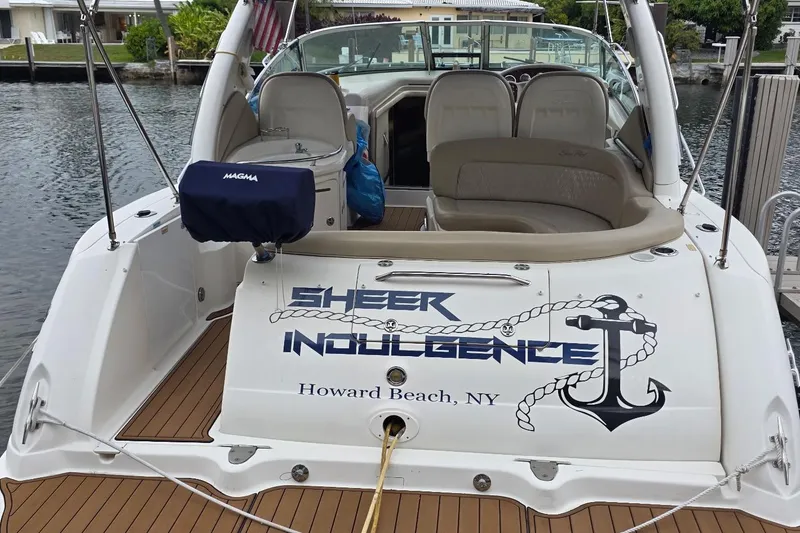 Slide: The Image of 2004 Sea Ray 340 Sundancer docked, featuring "Sheer Indulgence" name and anchor graphic. - 3