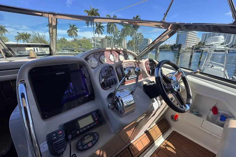Slide: The Image of Helm of 2004 Sea Ray 340 Sundancer with modern navigation equipment and scenic marina view. - 32