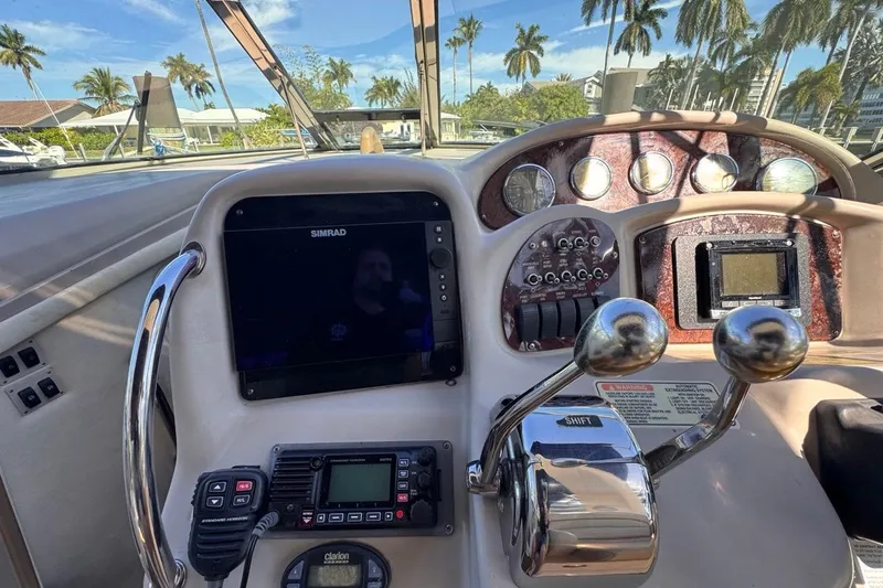 Slide: The Image of Cockpit of 2004 Sea Ray 340 Sundancer with navigation and control panels. - 35