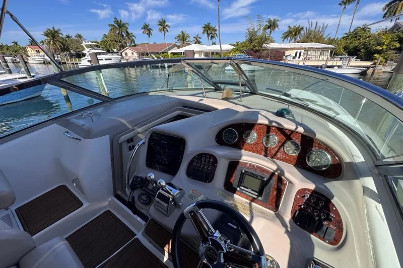 Slide: The Image of Cockpit view of 2004 Sea Ray 340 Sundancer boat with control panel and steering wheel. - 39