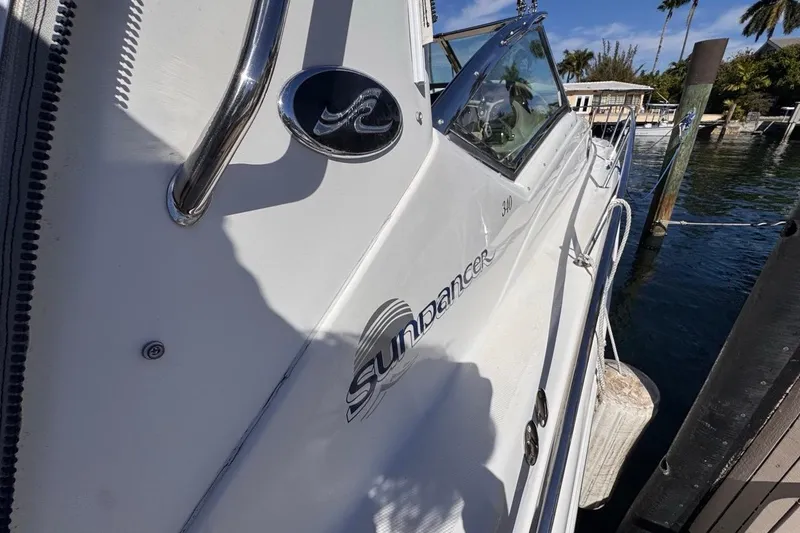 Slide: The Image of 2004 Sea Ray 340 Sundancer docked, showcasing sleek design and branding. - 42
