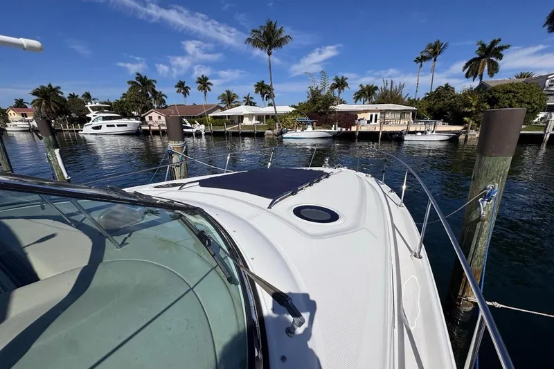 Slide: The Image of 2004 Sea Ray 340 Sundancer docked in a scenic marina with palm trees. - 43
