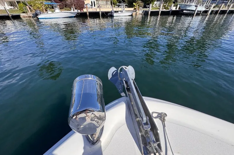Slide: The Image of Bow of 2004 Sea Ray 340 Sundancer with anchor, docked in calm waters. - 48