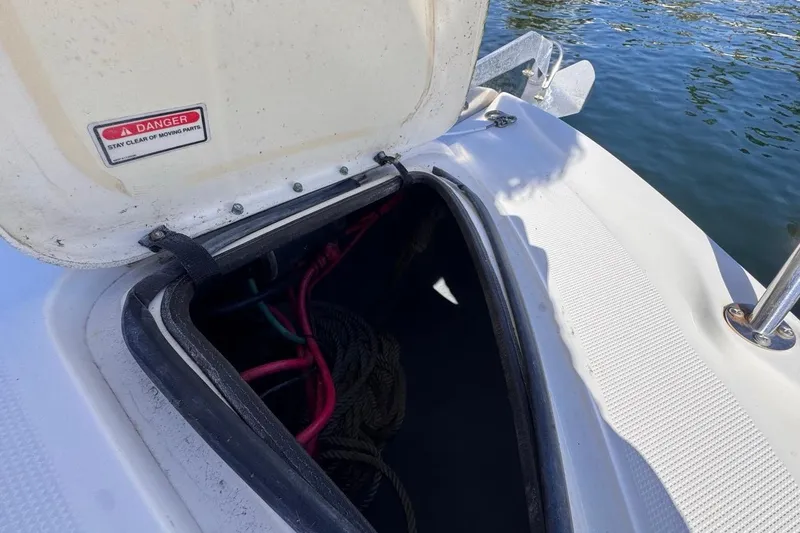 Slide: The Image of Open storage compartment on 2004 Sea Ray 340 Sundancer boat, showing ropes and cables. - 50