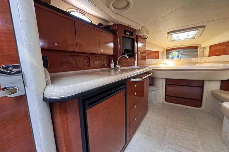 Slide: The Image of Luxurious interior of 2004 Sea Ray 340 Sundancer yacht with wood cabinetry and kitchenette. - 55