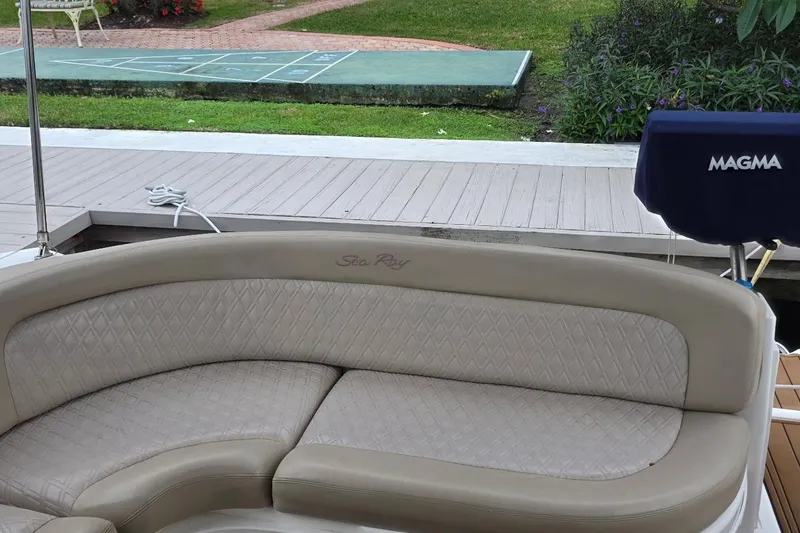 Slide: The Image of 2004 Sea Ray 340 Sundancer docked at marina with palm trees and clear sky. - 6