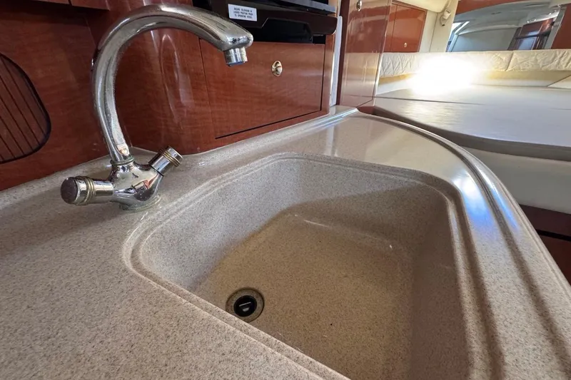 Slide: The Image of 2004 Sea Ray 340 Sundancer interior with sink and faucet in cabin. - 60