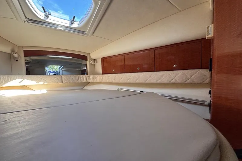 Slide: The Image of Interior cabin of 2004 Sea Ray 340 Sundancer with skylight and wooden cabinets. - 62