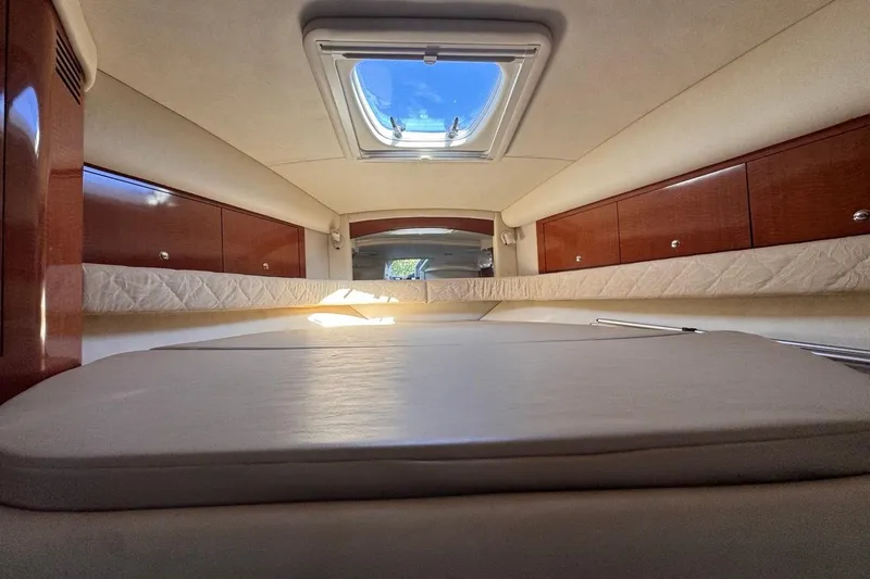 Slide: The Image of Luxurious interior of 2004 Sea Ray 340 Sundancer yacht with skylight and wooden cabinets. - 63