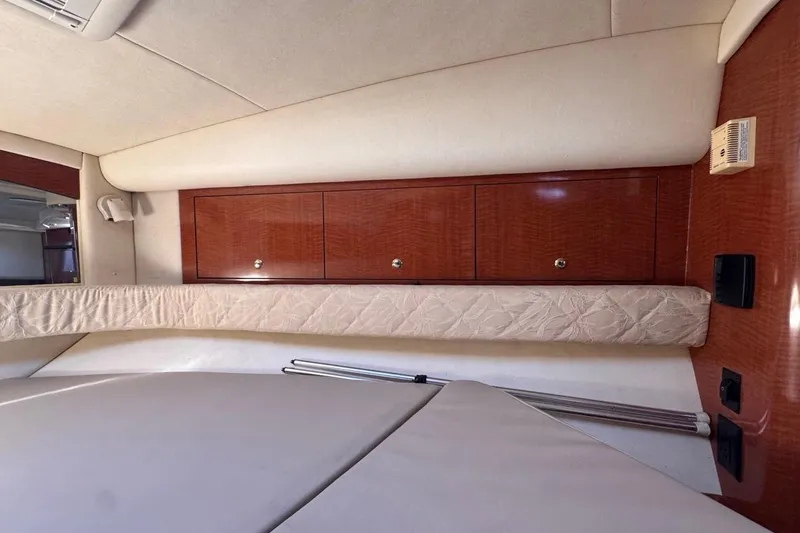 Slide: The Image of Interior cabin of 2004 Sea Ray 340 Sundancer with wooden cabinets and cushioned seating. - 65