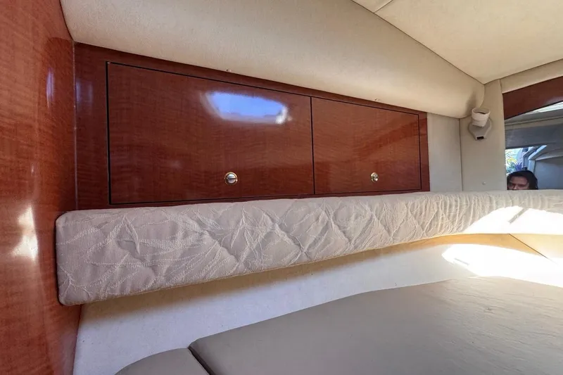 Slide: The Image of Interior cabin of 2004 Sea Ray 340 Sundancer with wood cabinets and cushioned seating. - 66