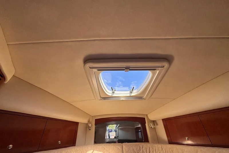 Slide: The Image of Interior cabin view of 2004 Sea Ray 340 Sundancer with skylight and wooden cabinets. - 67
