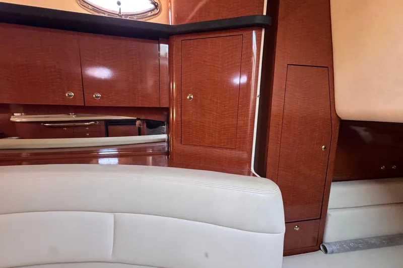 Slide: The Image of Interior of 2004 Sea Ray 340 Sundancer with wood cabinetry and cream seating. - 69