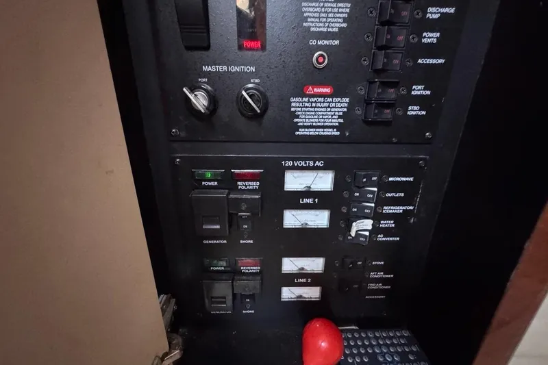 Slide: The Image of Electrical control panel of a 2004 Sea Ray 340 Sundancer boat, featuring switches and gauges. - 72