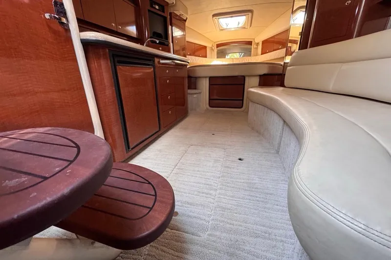 Slide: The Image of 2004 Sea Ray 340 Sundancer interior with wood cabinetry and cream seating. - 73