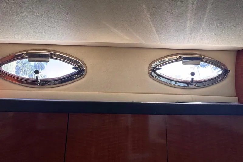 Slide: The Image of Oval windows inside a 2004 Sea Ray 340 Sundancer yacht cabin. - 78