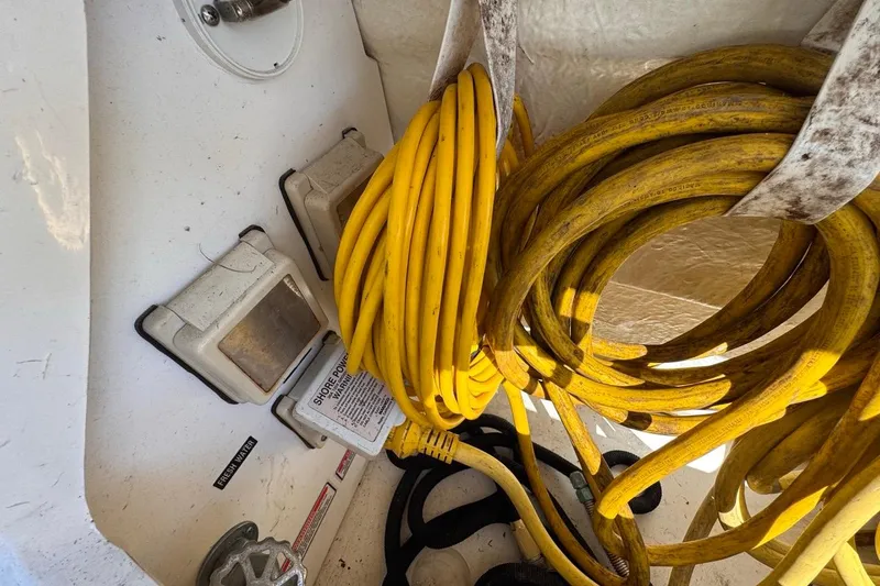 Slide: The Image of Coiled yellow power cables on a 2004 Sea Ray 340 Sundancer boat. - 79