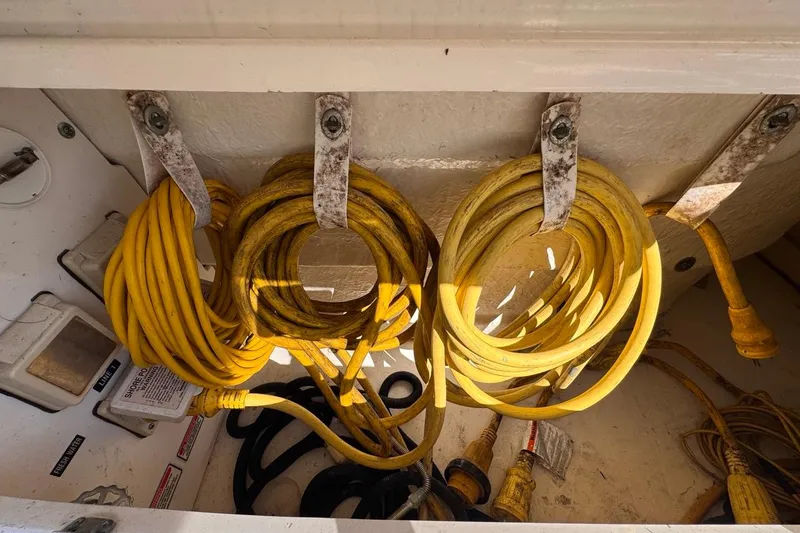 Slide: The Image of Yellow power cords stored on a 2004 Sea Ray 340 Sundancer boat. - 80