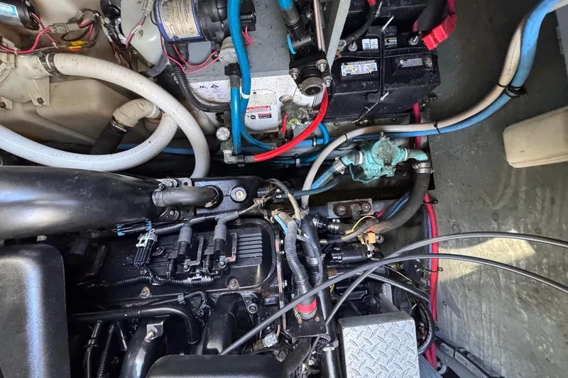 Slide: The Image of Engine compartment of a 2004 Sea Ray 340 Sundancer with visible wiring and components. - 83