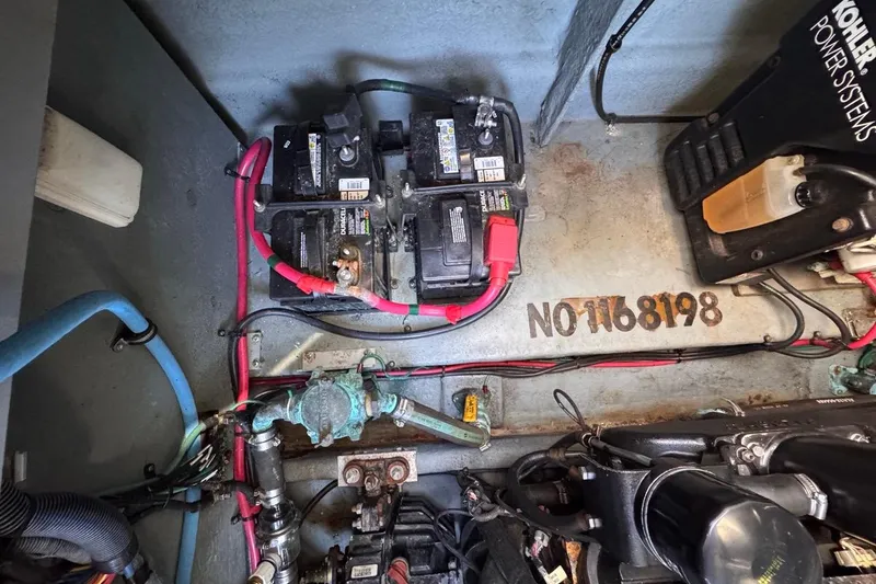 Slide: The Image of Engine compartment of 2004 Sea Ray 340 Sundancer with batteries and wiring. - 84