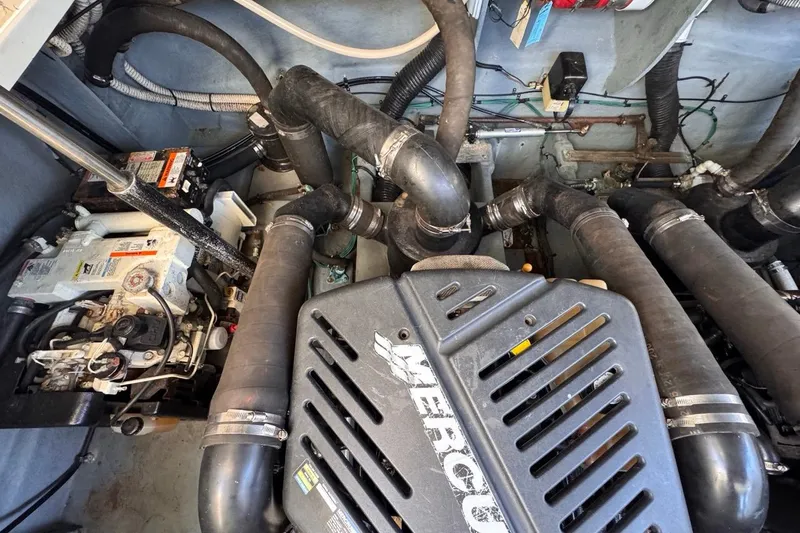 Slide: The Image of Engine compartment of a 2004 Sea Ray 340 Sundancer boat, featuring Mercury components. - 87
