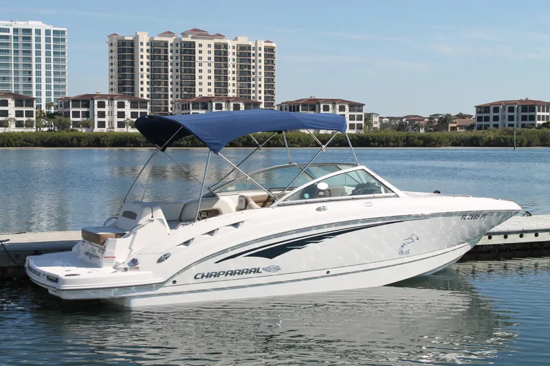Slide: The Image of 2015 Chaparral 224 Sunesta boat docked by waterfront buildings. - 16