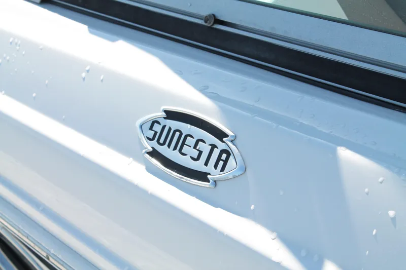 Slide: The Image of 2015 Chaparral 224 Sunesta logo on white boat exterior. - 23