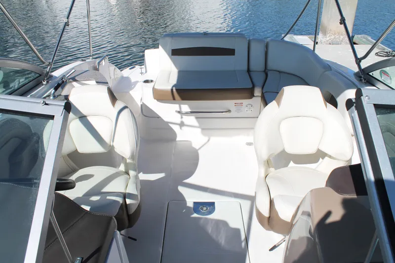 Slide: The Image of 2015 Chaparral 224 Sunesta boat interior with white seating and open deck layout. - 31