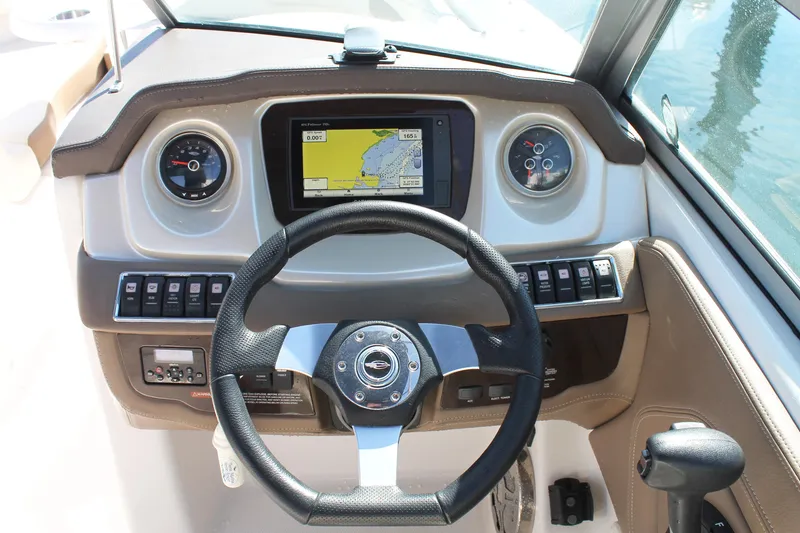 Slide: The Image of Dashboard of 2015 Chaparral 224 Sunesta boat with steering wheel and navigation display. - 33
