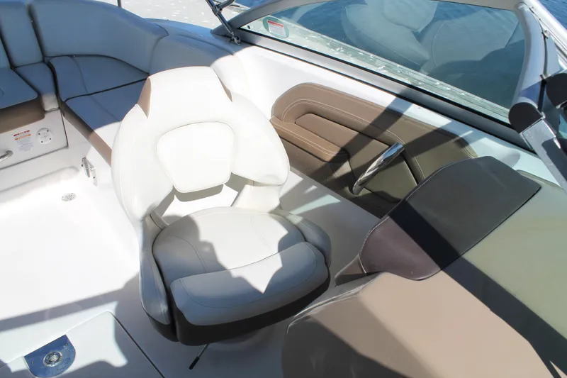 Slide: The Image of 2015 Chaparral 224 Sunesta boat interior with comfortable seating and steering wheel. - 37