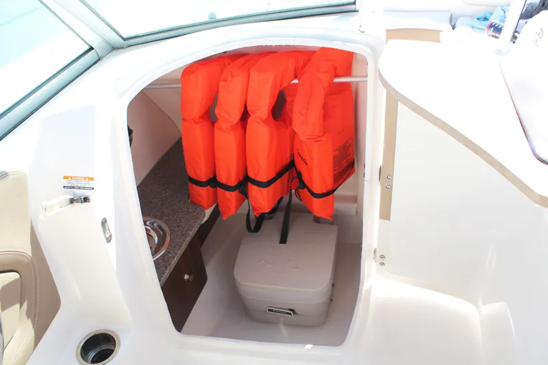 Slide: The Image of 2015 Chaparral 224 Sunesta boat storage with life jackets and cooler. - 40