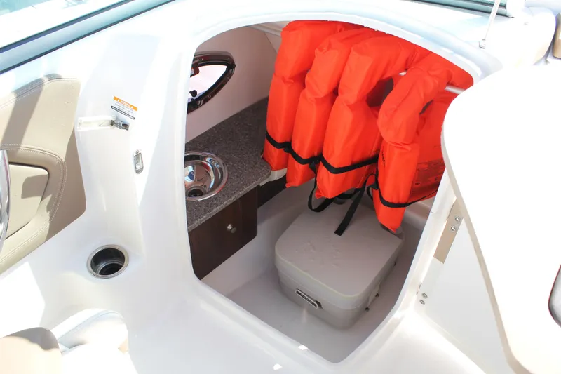 Slide: The Image of 2015 Chaparral 224 Sunesta boat interior with life jackets and storage area. - 41