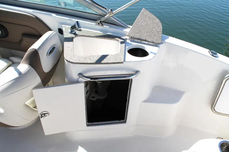 Slide: The Image of 2015 Chaparral 224 Sunesta boat interior with sink and storage compartment. - 43