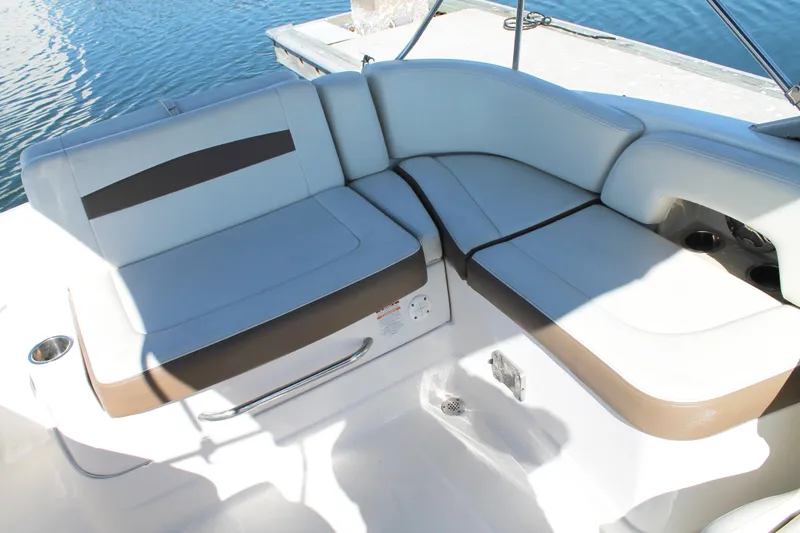 Slide: The Image of 2015 Chaparral 224 Sunesta boat interior seating with white and brown upholstery. - 47