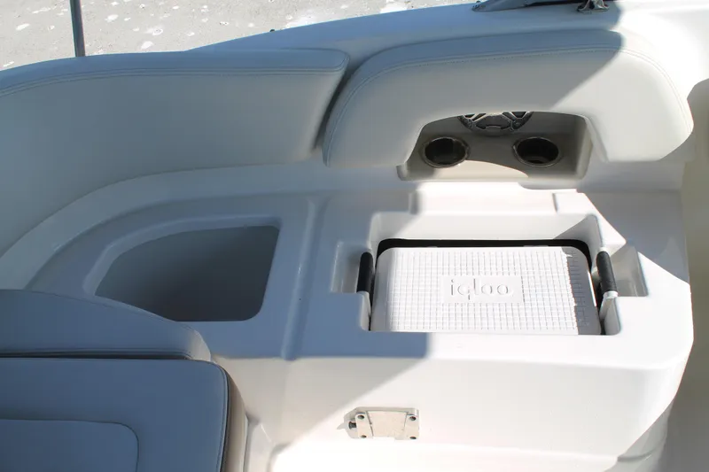 Slide: The Image of 2015 Chaparral 224 Sunesta boat interior with built-in cooler and cup holders. - 48
